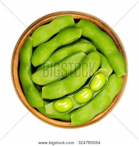 Green Soybeans In The Pod, Edamame, In Wooden Bowl. Unripe Soya Beans, Also Maodou. Glycine Max, A L