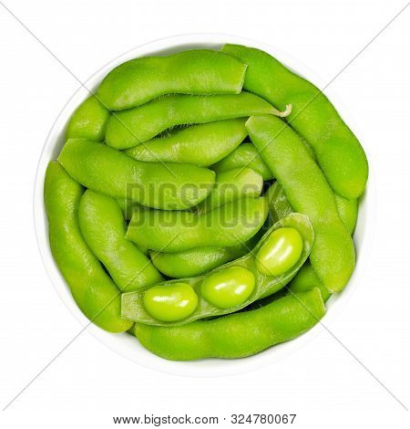 Green Soybeans In The Pod, Edamame, In White Bowl. Unripe Soya Beans, Also Maodou. Glycine Max, A Le