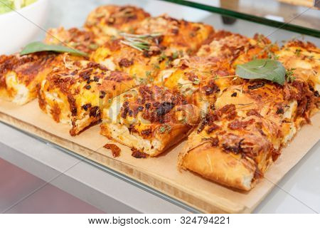 Foccaccia bread with cheese, tomatoes and basil on restaurant table