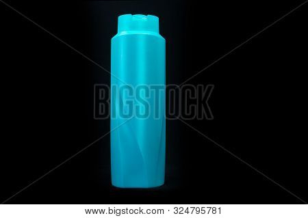 Teal, Plastic, Shampoo Bottle With No Labels. Isolated On A Black Background. The Product Cap Is Clo