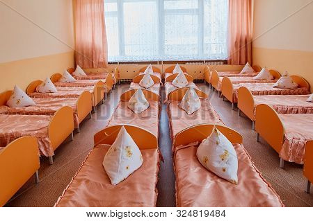 Cots In The Kindergarten. Orphanage Or Boarding School. Beds In A Boarding School Or In An Orphanage