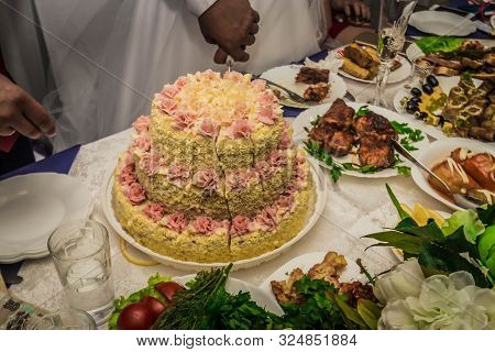 Bride And Groom Cut The Cake At The Wedding