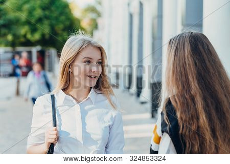 Happy Bright Positive Moments Of Two Stylish Girls Are Discussing Something On The Street In The Cit