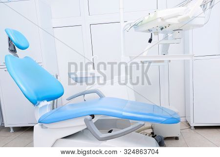 Dental Office Background With Chair. Dental Hygiene And Healthcare Concept.