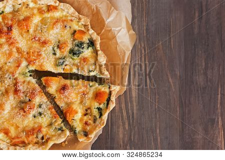 Delicious Quiche Or Tart With Vegetables, Spinach And Cheese On The Rustic Wooden Table