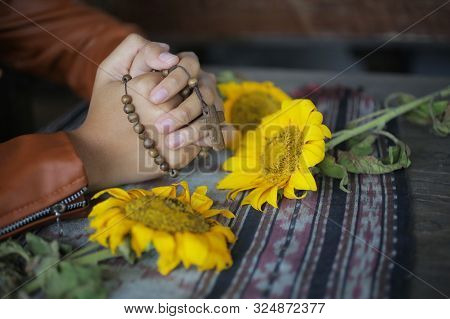 Young Junior Woman Praying Rosary. Female Hands Holding A Rosary With Jesus Christ Cross Crucifix. M
