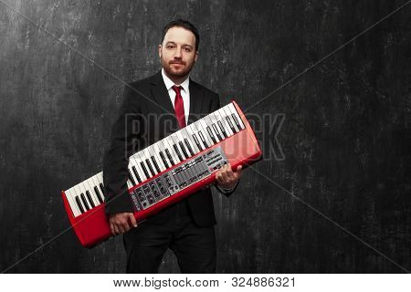Man Holds In His Hands An Electric Synthesizer, Piano