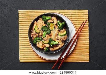 Hunan Chicken In Black Bowl At Dark Slate Background. Hunan Chicken Is Chinese Or Indo-chinese Cuisi