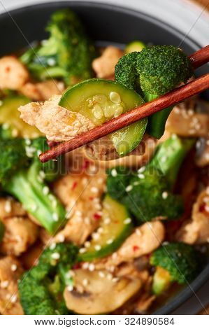 Hunan Chicken In Black Bowl At Dark Slate Background. Hunan Chicken Is Chinese Or Indo-chinese Cuisi