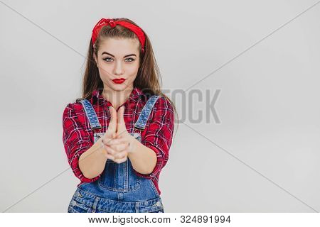 Adventurous Pretty Girl Standing Holding Her Hands Like A Pistol, Looking Confident.