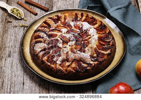 Eplekake. Traditional Norwegian Apple Cake Or Pie Sprinkled Sugar And Cinnamon On Old Rustic Wooden 