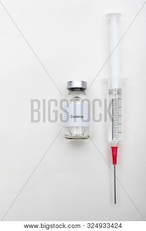 Medical Concept Showing Medical A Medical Vial Reading Codeine And A Syringe