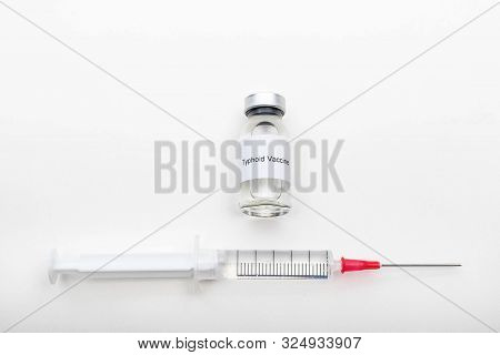 Medical Concept Showing Medical A Medical Vial Reading Typhoid Vaccine And A Syringe