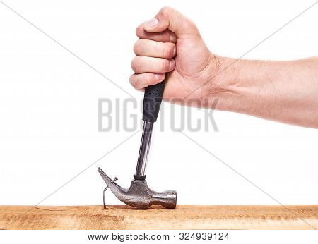 Hand Pulls Hammer Nail Out Of The Board, On An Isolated White Background.