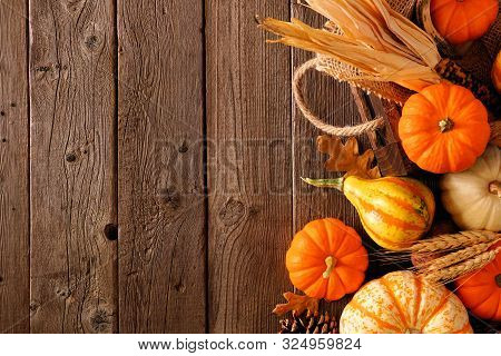 Fall Side Border Of Pumpkins, Gourds And Fall Decor With Harvest Basket On A Rustic Wood Background 