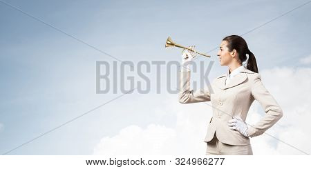 Business Woman Playing Trumpet Brass. Young Lady In White Business Suit And Gloves Posing With Music