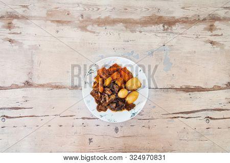 Beef meat stewed with potatoes-Traditional French cuisine Beef Bourguignon potatoes carrots in persillade