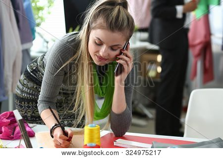 Fashion Clothes To Bespoke Designer Talking Phone. Busy Young Woman With Smartphone. Caucasian Seams