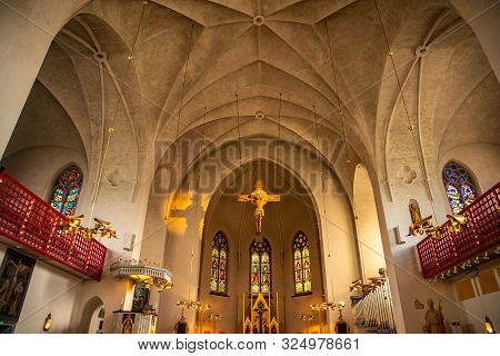 Lulea Sweden Catholic Cathedral In Sunlight, Statue Of Jesus On Cross Sunset