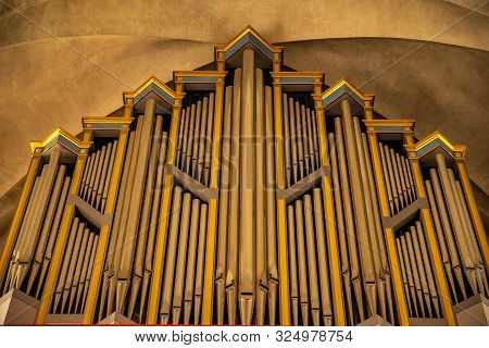 Organ In Catholic Cathedral For Singing Prayers In Sunlight