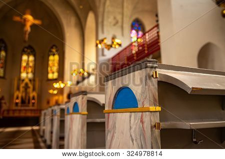 Prayer Stand Catholic Cathedral Lulea Sweden In Sunlight, Statue Of Jesus On Cross Sunset