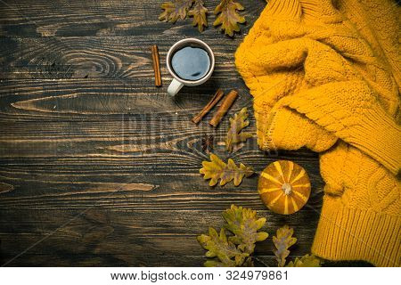 Autumn Flat Lay Background With Coffee, Knitwear And Yellow Leaves.