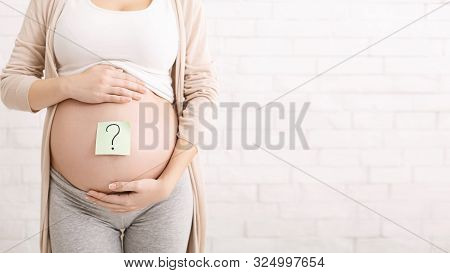 Choosing Baby Name. Pregnant Woman Embracing Her Belly With Question Mark On It, Panorama With Free 