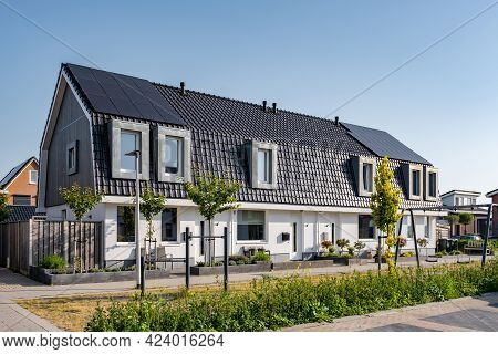 Newly Build Houses With Solar Panels Attached On The Roof Against A Sunny Sky Close Up Of New Buildi
