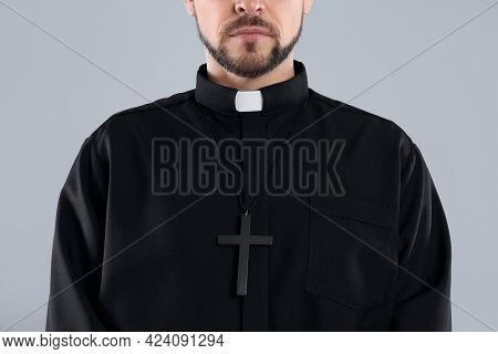 Priest Wearing Cassock With Clerical Collar On Grey Background, Closeup