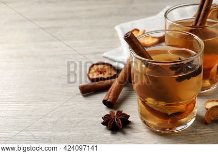 Delicious Compote With Dried Apple Slices, Anise And Cinnamon On White Wooden Table, Space For Text
