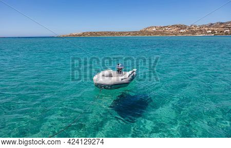 Dinghy Inflatable Boat On Turquoise Blue Sea Water