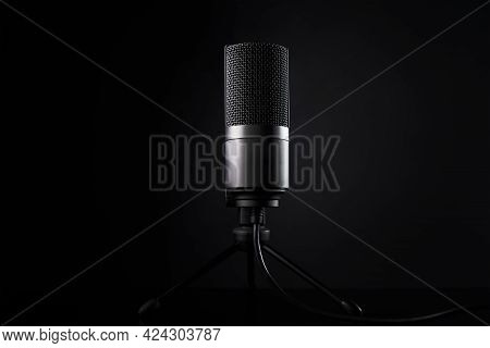 Studio Microphone On Dark Background With Copy Space. Black Professional Condencer Microphone. Podca