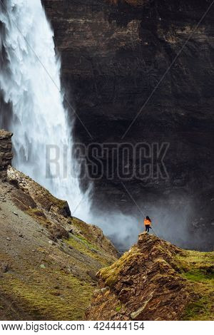 Female photographer at the Haifoss waterfall, Iceland