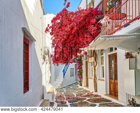 Romantic Traditional Alleyways Of Greek Island Towns. Whitewashed Walls, Colorful Doors, Pink Bougai