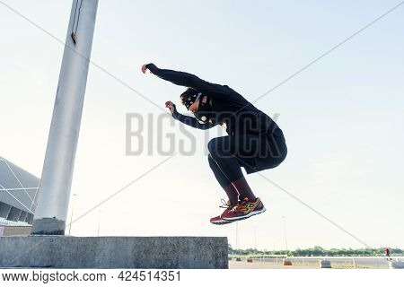 Strong And Handsome Healthy Bearded Man Doing Plyometric Jump Exercise In Crossfit Workout Outdoors.