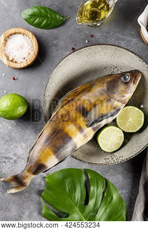 Raw Fish Sea Bass Or Lingcod And Seasonings For Cooking It On A Gray Background Top View Vertical Ph