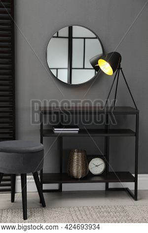 Console Table With Stool And Mirror On Grey Wall In Room. Interior Design
