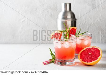 Grapefruit Summer Coctail Grink With Slice Of Grapefruit And Rosemary On White Background, Copy Spac