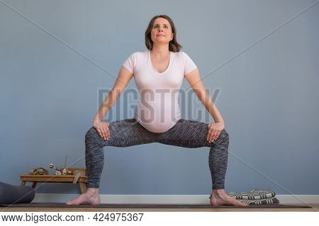 Pregnant Woman Standing In Sumo Squat Exercise, Goddess Pose