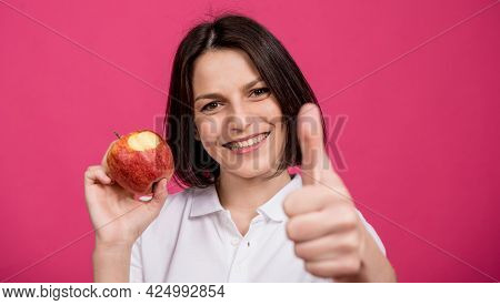 Beautiful Young Woman Hold A Big Apple In Her Hand