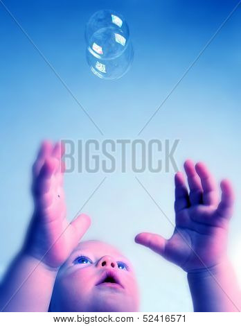 baby playing with soap bubbles