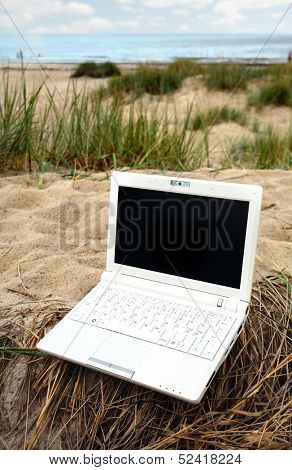White small Laptop on the beach
