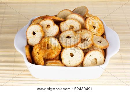 Small round mini bake rolls with a hole inside in a white bowl