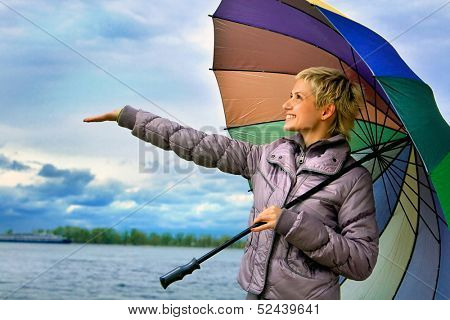 Girl with multi-coloured umbrella.