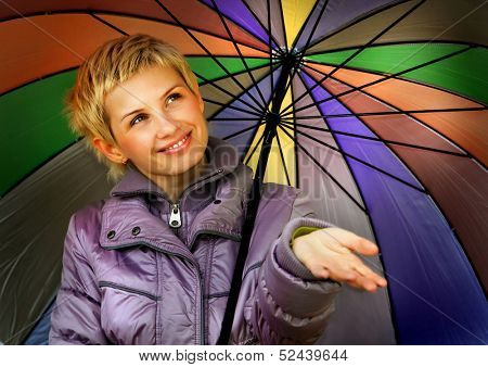 Girl with multi-coloured umbrella.