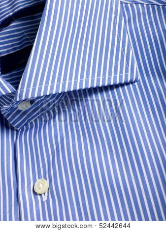 A part of a blue laced shirt with buttons