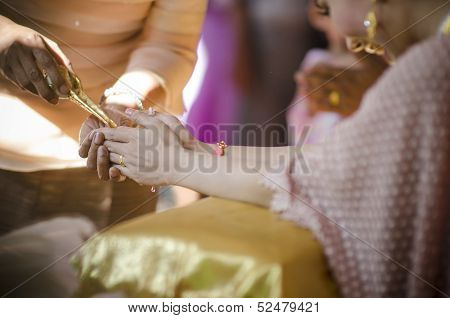 Hands Pouring Blessing Water Into Bride's Bands, Thai Wedding Ceremony