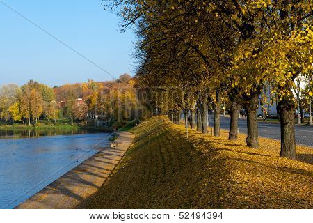Vilnius city on sunny autumn day, Neris river in Vilnius, Lithuania, city scene with autumn trees