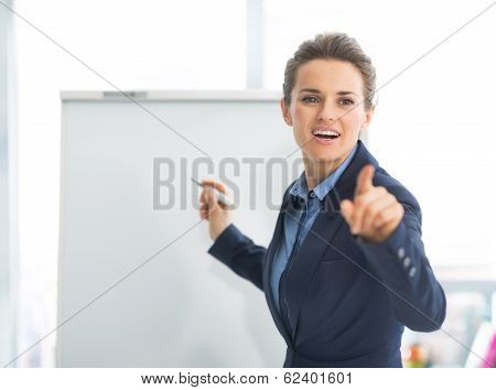 Business Woman Near Flipchart Pointing On Listener