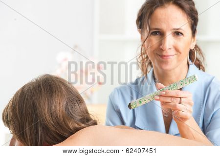 Alternative medicine therapist doing moxa treatment on her client